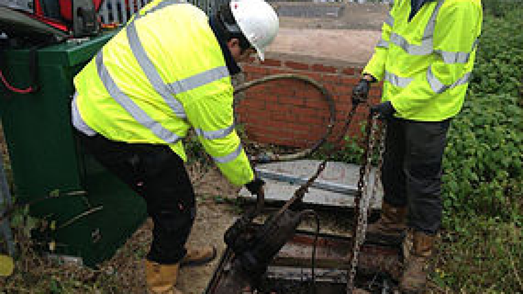 An image of two engineers inspecting a submersible pump