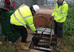 An image of two engineers inspecting a submersible pump