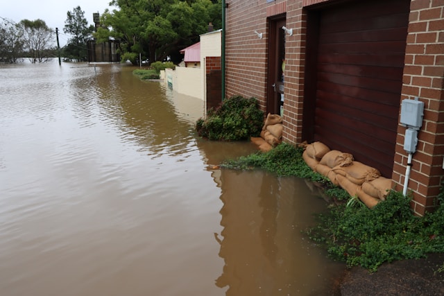A photo showcasing a flooded area and sandbags blocking an area