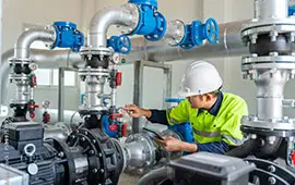 An image of an engineer inspecting pumps