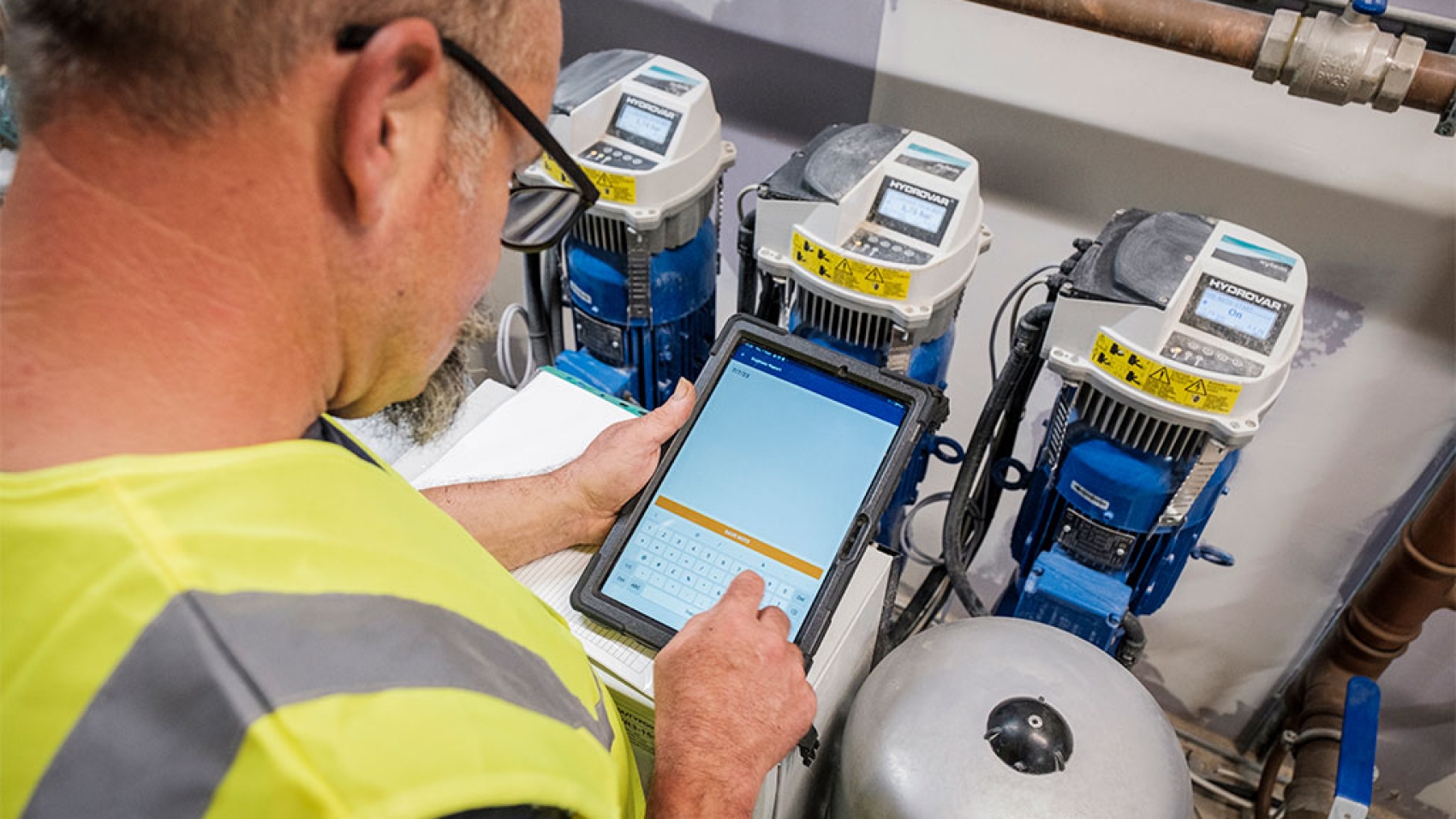 engineer checking readings on a tablet