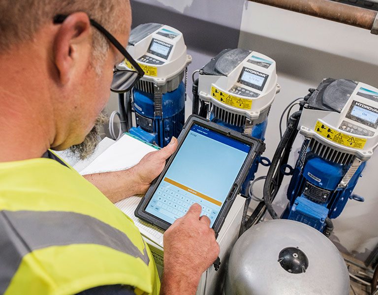 engineer checking readings on a tablet