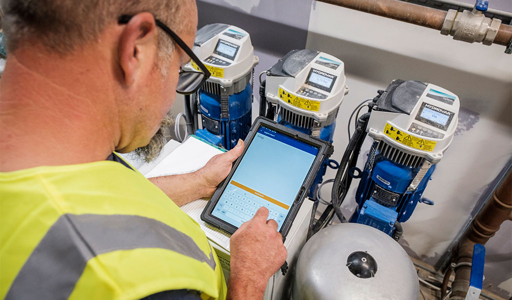 engineer checking readings on a tablet