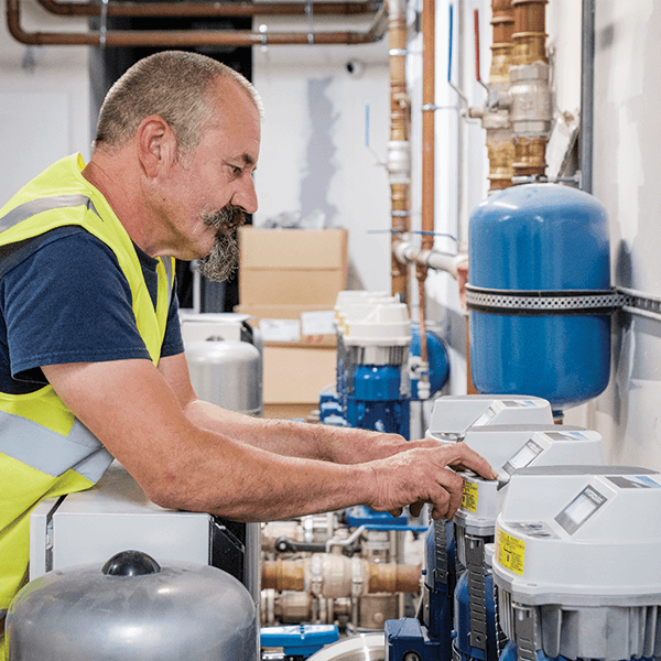 An image of an engineer programming a booster set