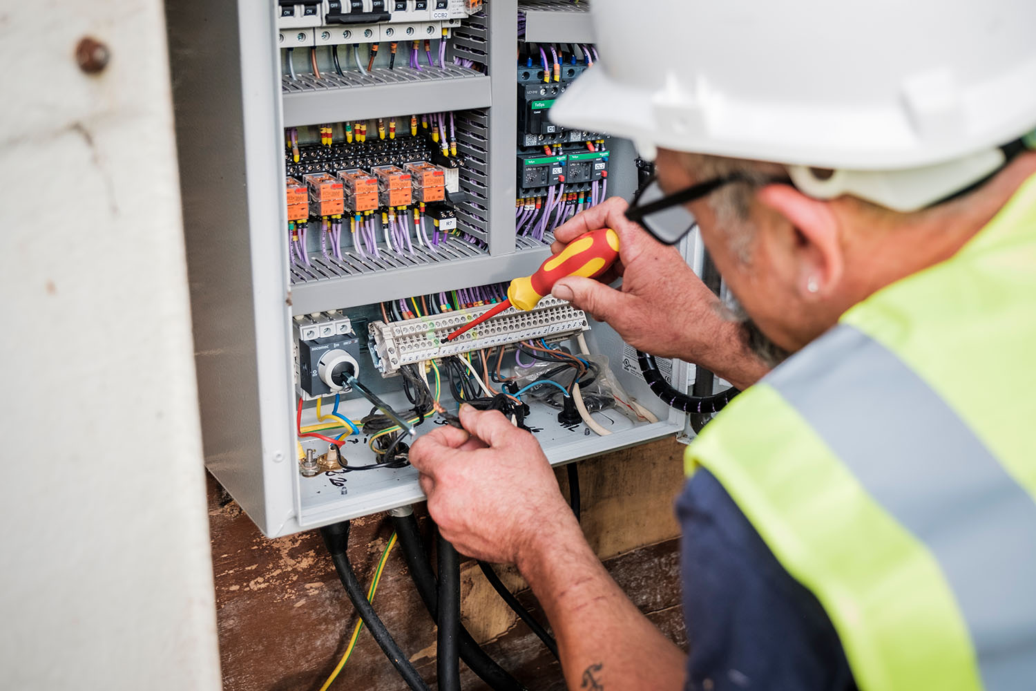 An image of an engineer fixing a control panel
