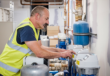An image of an engineer programming a booster set