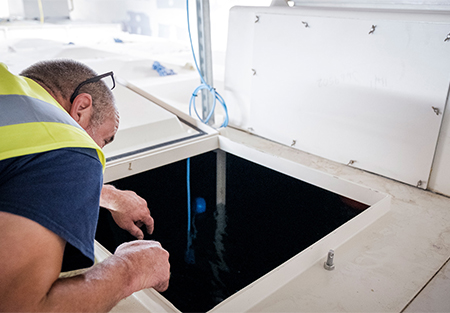 engineer inspecting a cold water tank