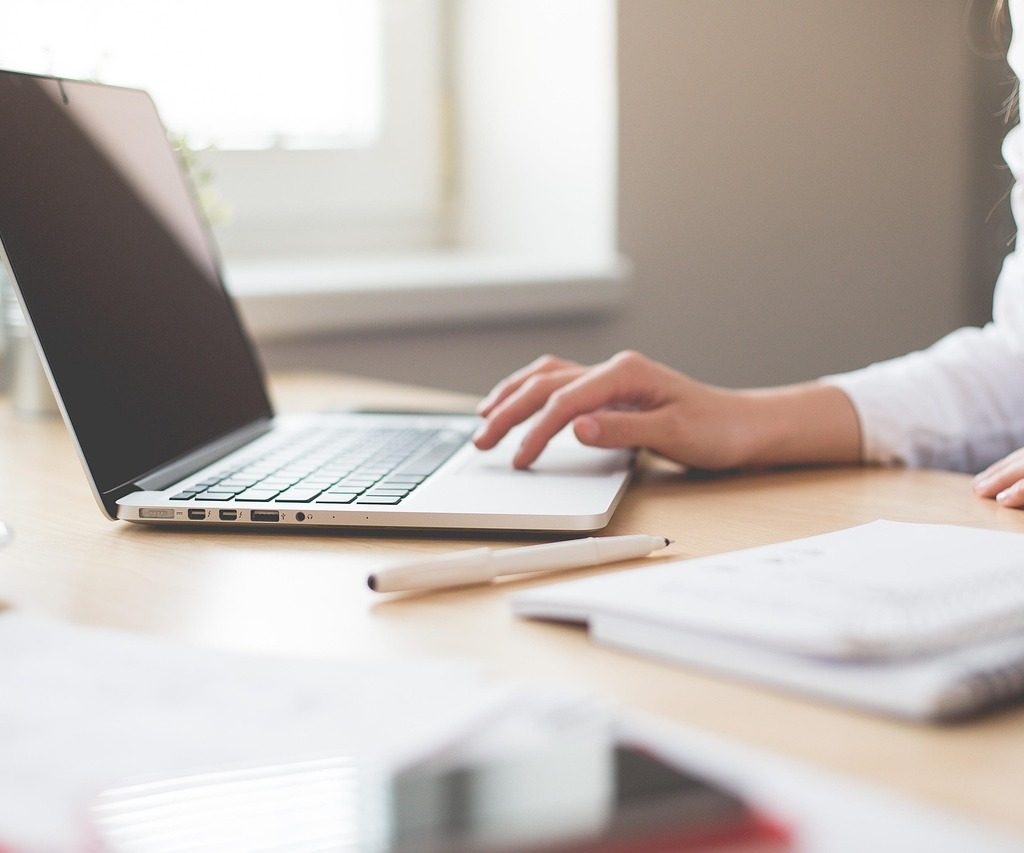 An image of a lady working on a laptop